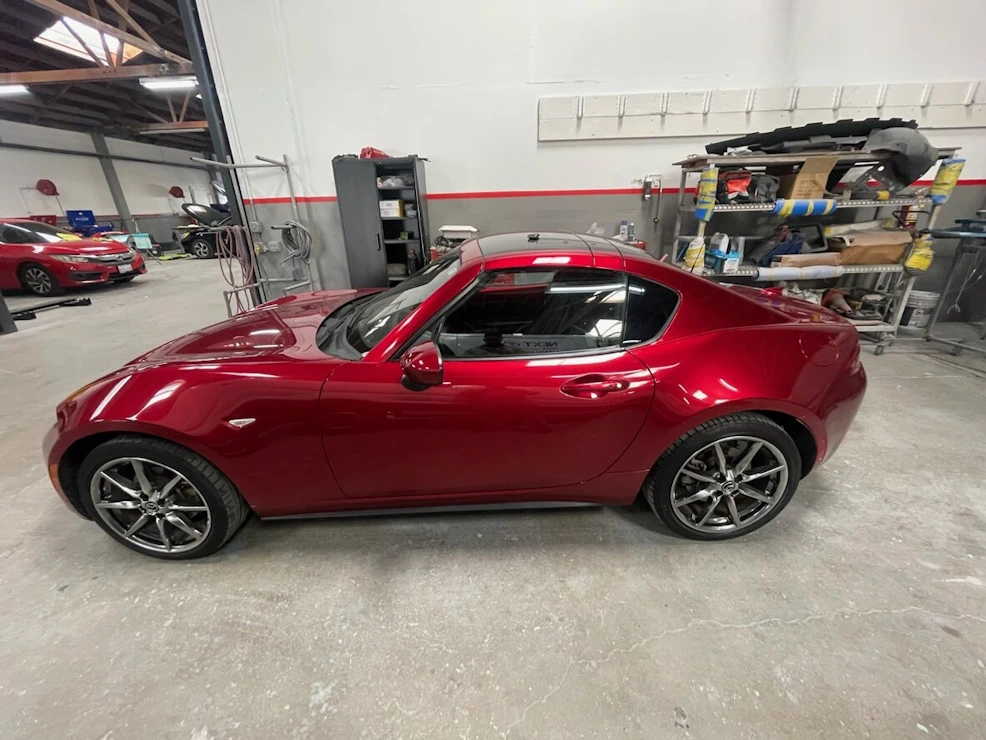 Removed dent from from side door of red car